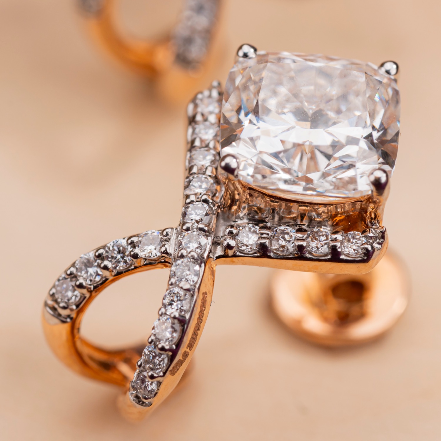 A KAHA pendant and matching earring in rose gold