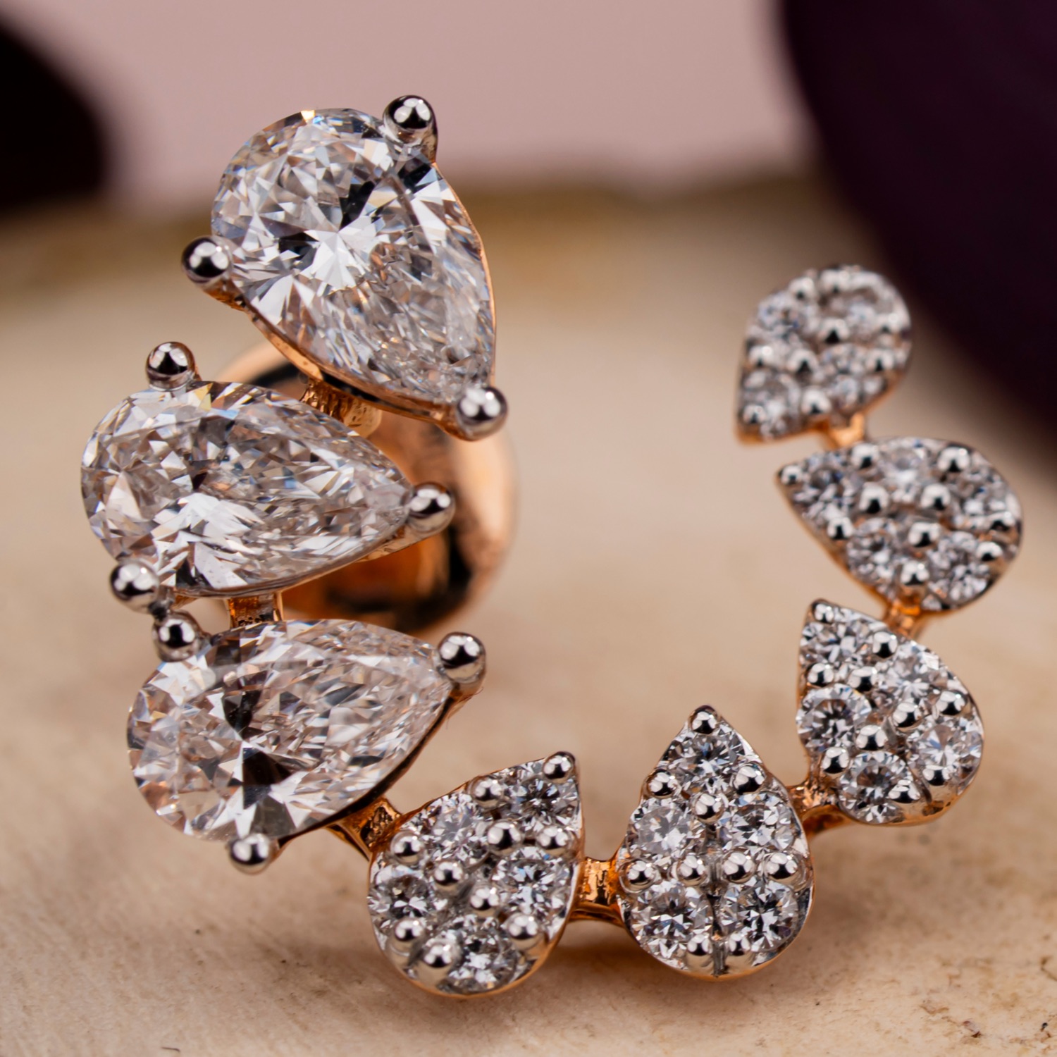 A pear-cut diamond cluster ring in rose gold